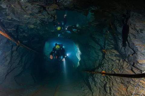 Diver explores the Nuttlar slate mine in Bestwig, Germany 